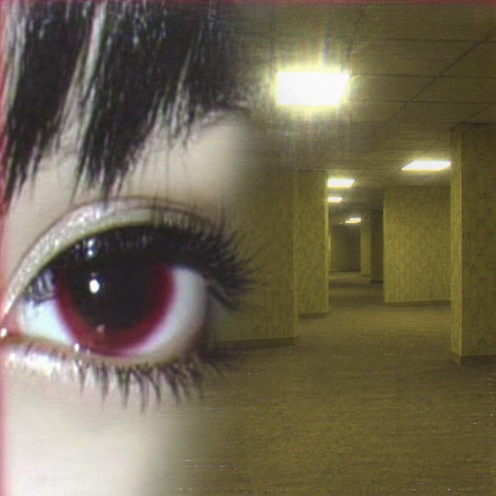 A huge burgundy eye dissolving into empty yellow backrooms